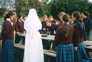 Dominican sister with students outside