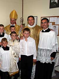 Bishop Fellay and priests with confirmandi