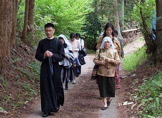 priest leading pilgrims